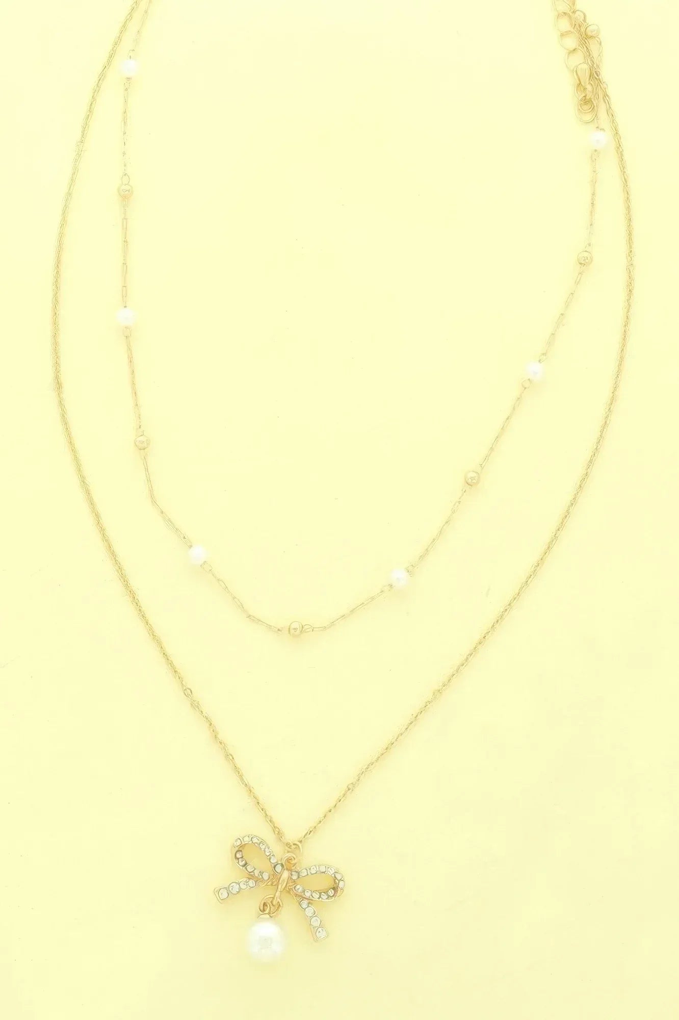 Dual-strand Jewled Bow Pendant Necklace | Mixtshop LLC Main image